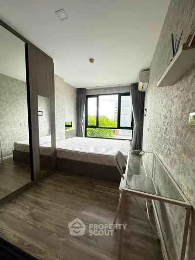 Modern bedroom with large window and stylish decor in urban apartment