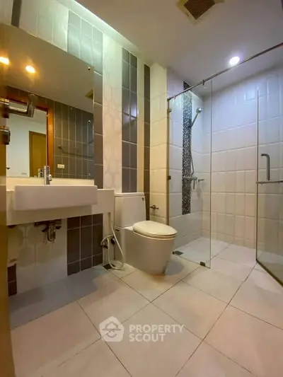 Modern bathroom with glass shower and stylish tile design