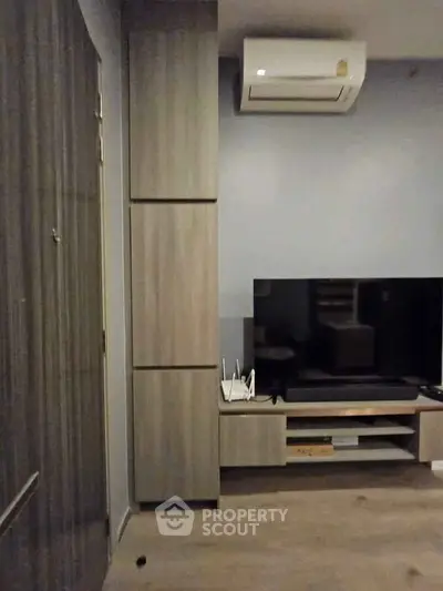 Modern living room with sleek TV unit and air conditioning