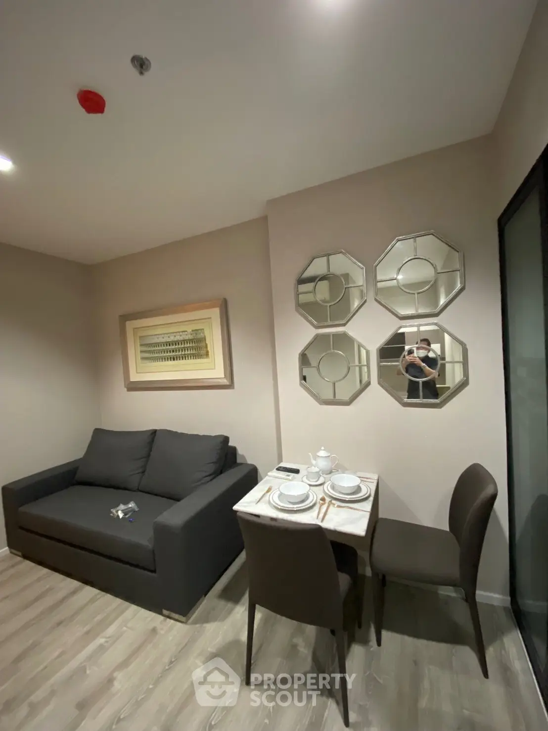 Cozy living room with modern decor and dining area in a stylish apartment.