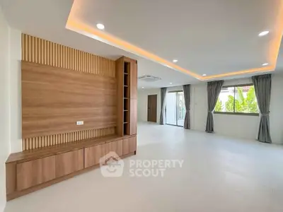 Spacious modern living room with elegant wood paneling and large windows