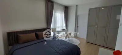 Modern bedroom with stylish decor and ample natural light