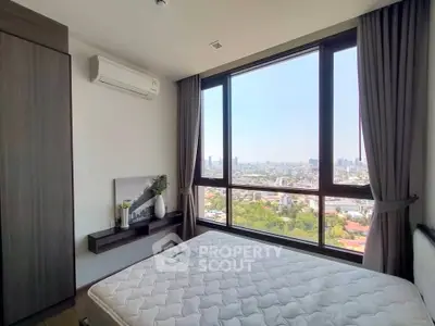 Modern bedroom with large windows offering stunning city views and natural light.