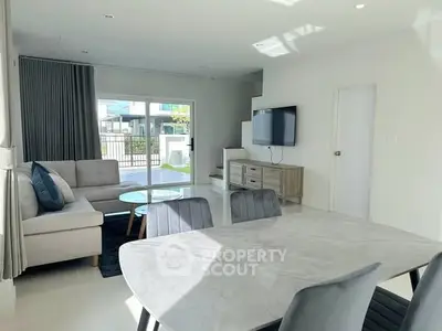 Modern living room with sleek furniture and natural light, perfect for family gatherings.