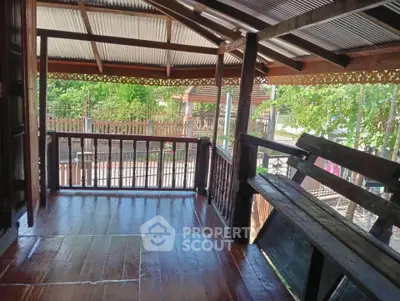 Charming wooden balcony with rustic design and garden view