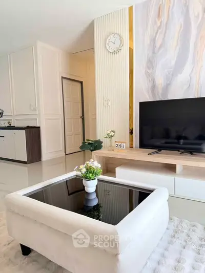 Modern living room with sleek TV stand, elegant decor, and stylish coffee table in a bright, airy space.
