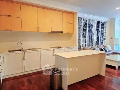Modern open kitchen with wooden cabinets and island in a stylish apartment