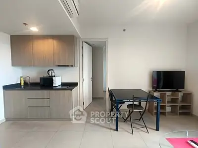 Modern apartment interior with kitchen and dining area, featuring sleek cabinetry and minimalist design.