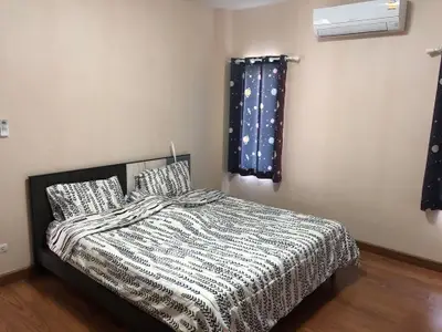 Cozy bedroom with modern decor and air conditioning in a stylish apartment.