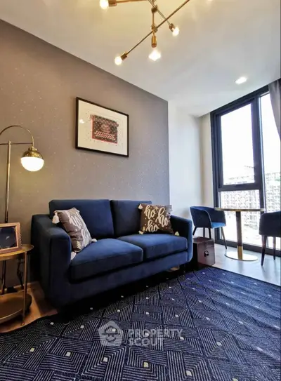 Modern living room with stylish blue sofa and city view window