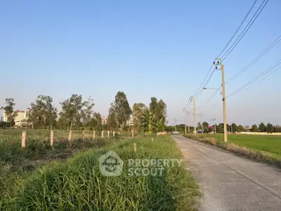 Expansive rural land with clear skies and lush greenery, perfect for development opportunities.