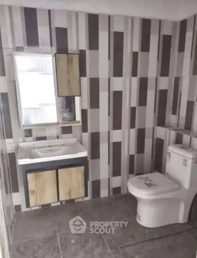 Modern bathroom with stylish tile design and contemporary fixtures.