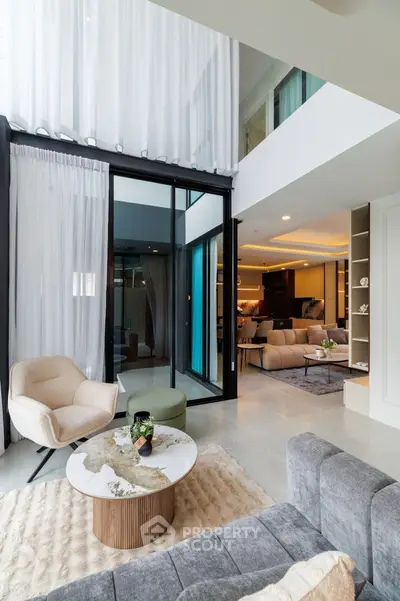 Luxurious modern living room with high ceilings and elegant decor