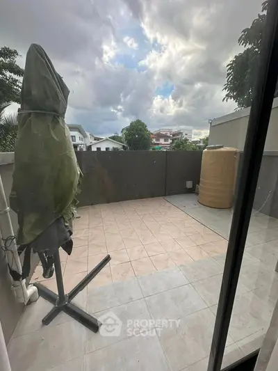 Spacious balcony with tiled flooring and scenic view, perfect for outdoor relaxation.