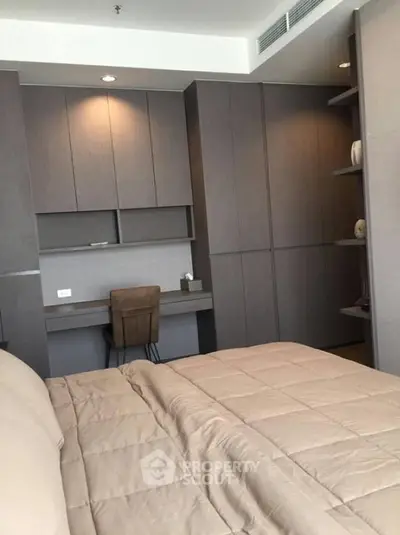 Modern bedroom with built-in study desk and sleek cabinetry