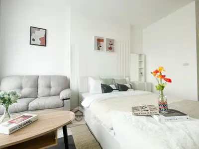Stylish modern bedroom with cozy seating area and elegant decor