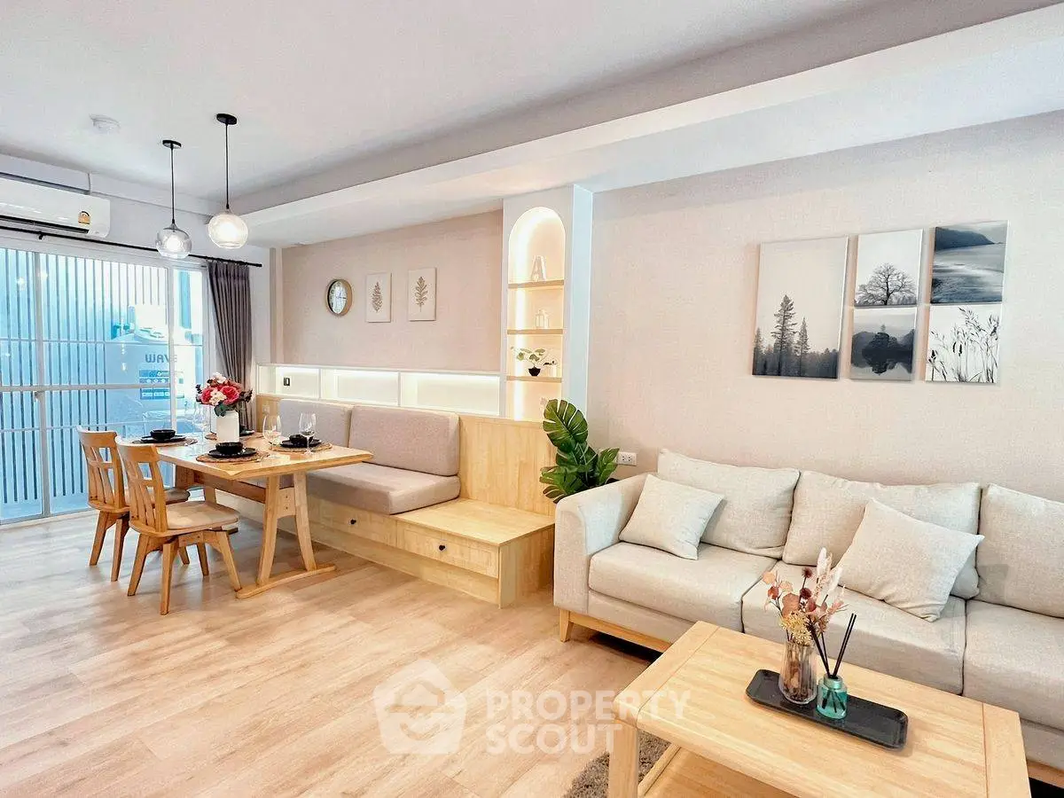 Modern living room with cozy seating and elegant dining area
