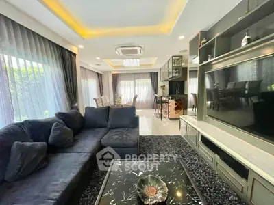 Luxurious living room with modern decor, large windows, and elegant furniture in a stylish home.