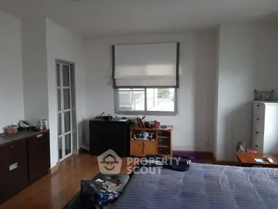 Spacious bedroom with modern decor and ample natural light