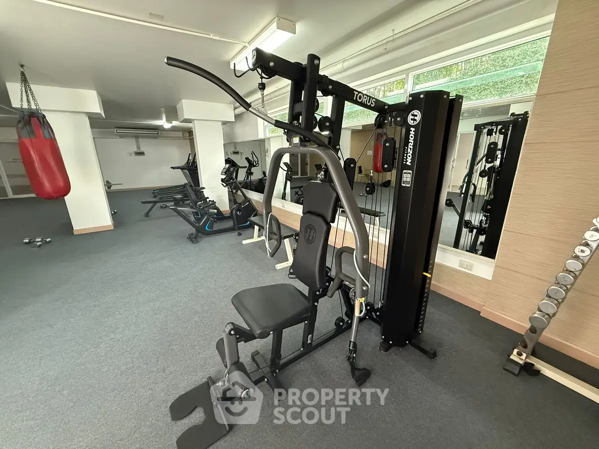 Spacious home gym with modern exercise equipment and natural light.