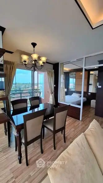 Luxurious dining area with elegant chandelier and stunning balcony view in modern apartment