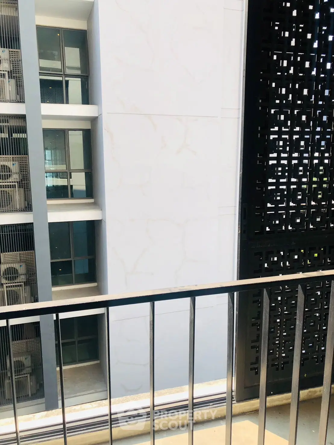 Modern apartment balcony with stylish railing and architectural view