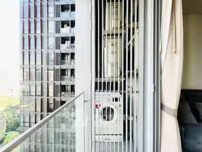 Modern high-rise balcony with washing machine and city view