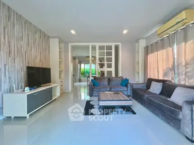 Spacious modern living room with stylish decor and ample natural light.