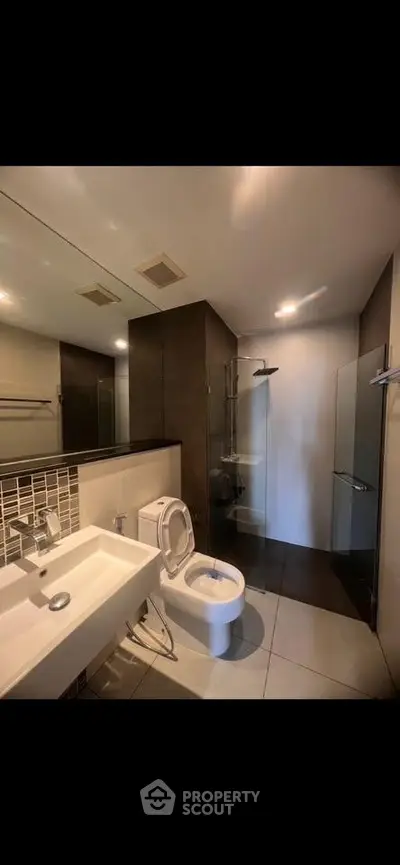 Modern bathroom with sleek fixtures and glass shower enclosure