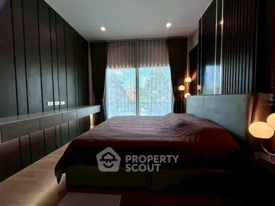 Luxurious modern bedroom with elegant lighting and large window view.