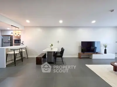 Spacious modern living room with open kitchen and sleek design