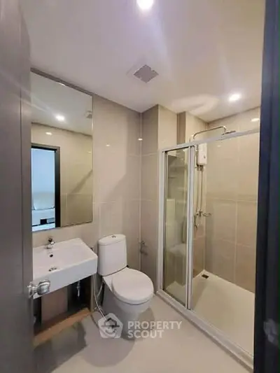 Modern bathroom with sleek fixtures and glass shower enclosure