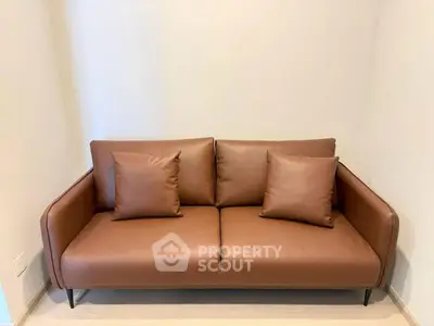 Modern brown leather sofa in minimalist living room setting