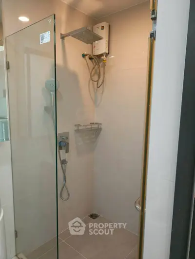Modern bathroom with glass shower enclosure and sleek fixtures
