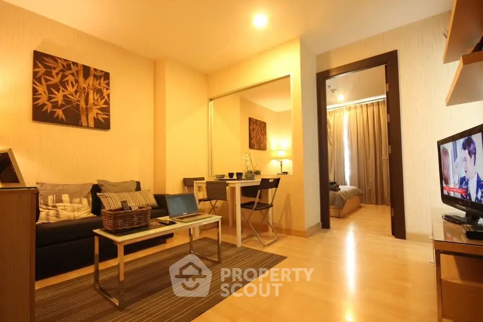 Cozy living room with modern decor and open view into bedroom, perfect for urban living.