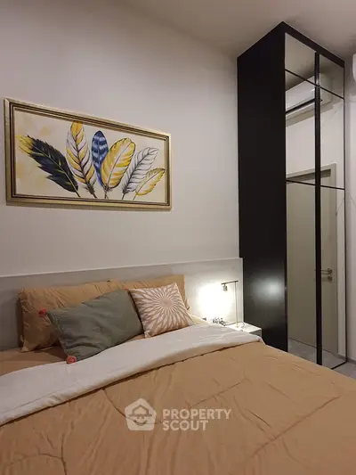 Cozy bedroom with modern decor and stylish artwork, featuring a comfortable bed and sleek wardrobe.