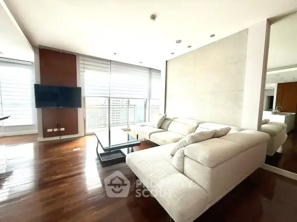 Spacious modern living room with large windows and elegant furnishings