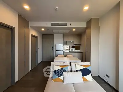 Modern open-plan living room with stylish kitchen and dining area.