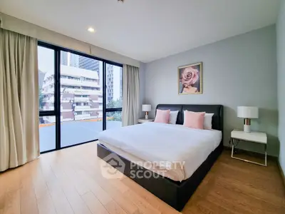 Spacious bedroom with modern decor and large window offering city view