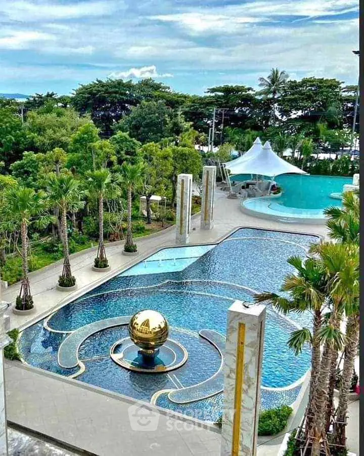 Luxurious resort-style pool with palm trees and unique golden globe feature.