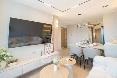 Modern living room with sleek design, large TV, and elegant dining area, perfect for contemporary urban living.