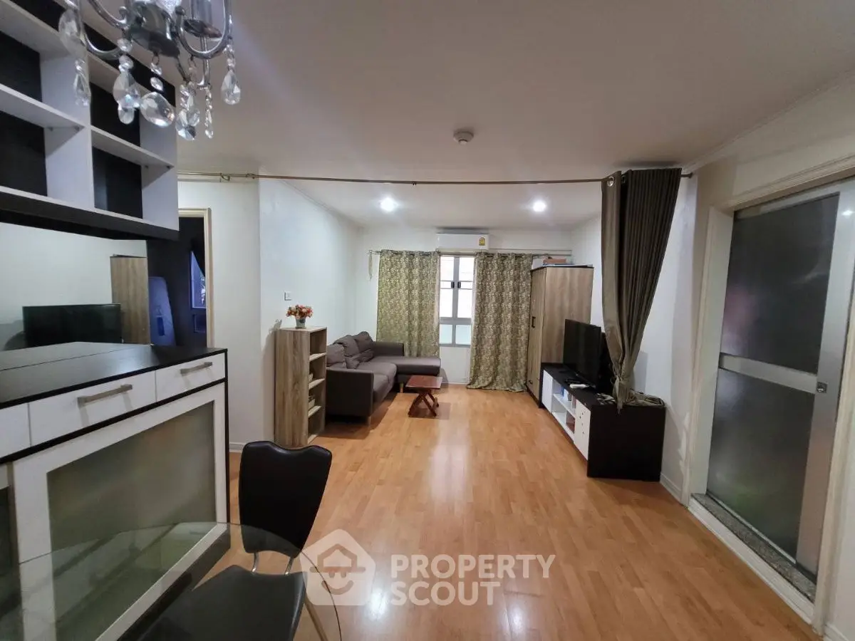 Spacious living room with modern decor and hardwood flooring