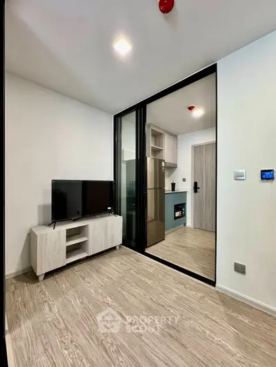 Modern living room with sleek kitchen and stylish decor