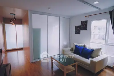 Modern living room with glass sliding doors and cozy seating area