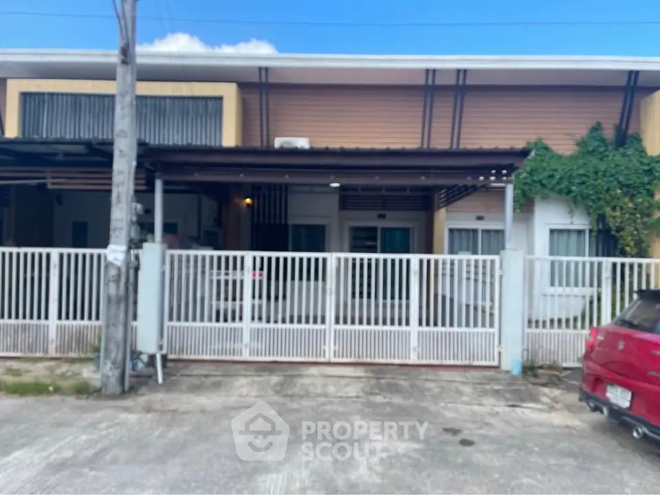 Charming single-story home with gated entrance and lush greenery, perfect for family living.