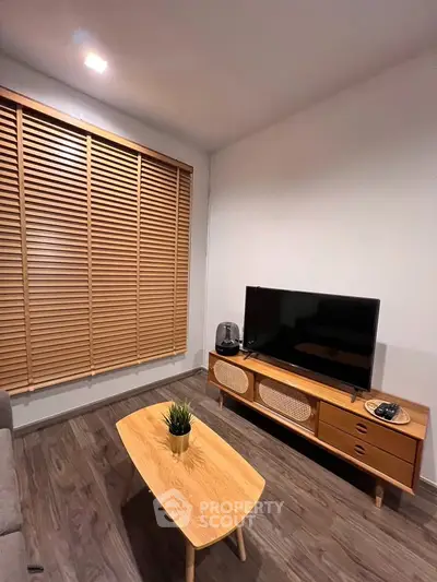 Modern living room with stylish wooden furniture and large window blinds