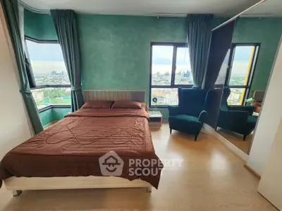 Spacious bedroom with city view, modern furnishings, and large windows for natural light.