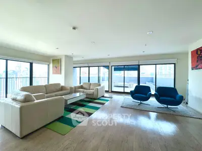 Spacious modern living room with large windows and stylish furniture