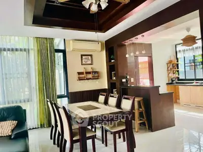 Elegant open-layout dining and kitchen area with modern decor and natural light.