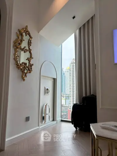 Luxurious high-rise apartment with elegant decor and stunning city view through floor-to-ceiling windows.